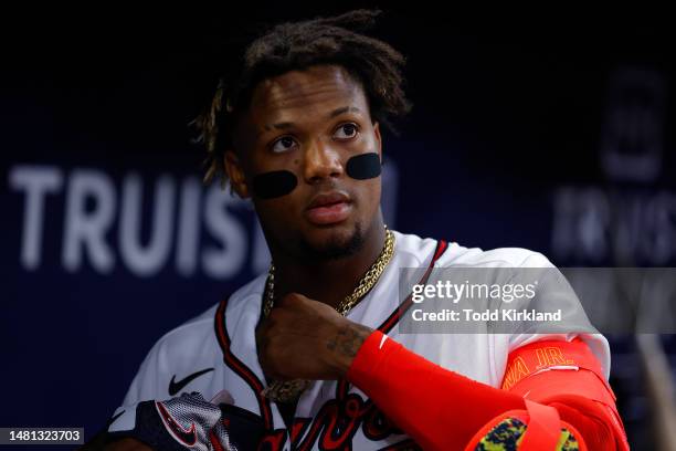 Ronald Acuna Jr. #13 of the Atlanta Braves looks on from the dugout during the seventh inning against the Cincinnati Reds at Truist Park on April 10,...