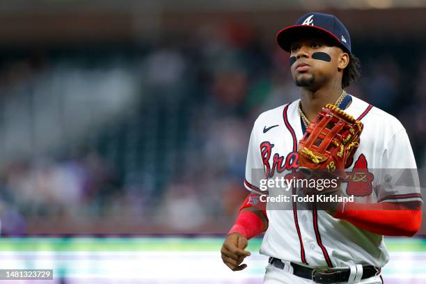 Ronald Acuna Jr. #13 of the Atlanta Braves returns to the dugout during the tenth inning against the Cincinnati Reds at Truist Park on April 10, 2023...