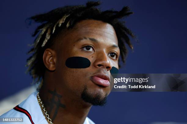 Ronald Acuna Jr. #13 of the Atlanta Braves looks on from the dugout during the seventh inning against the Cincinnati Reds at Truist Park on April 10,...