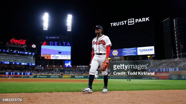 Ronald Acuna Jr. #13 of the Atlanta Braves returns to the dugout during the ninth inning against the Cincinnati Reds at Truist Park on April 10, 2023...