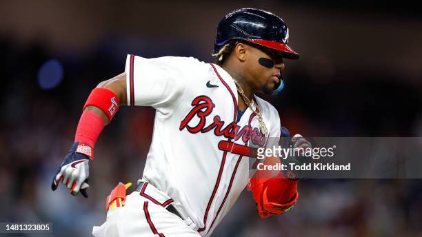 Ronald Acuna Jr. #13 of the Atlanta Braves races to first for a single during the seventh inning against the Cincinnati Reds at Truist Park on April...
