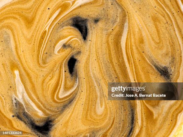 full frame, textures of the cream of a cup of fresh coffee. - chocolate swirls foto e immagini stock