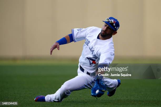 American League All-Star Jose Bautista of the Toronto Blue Jays makes a diving catch on a ball hit by National League All-Star Ryan Braun of the...