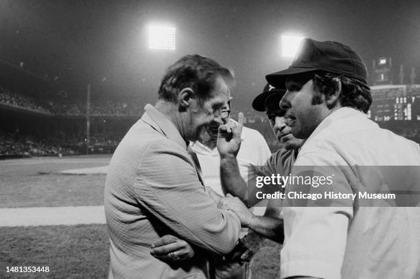 Bill Veeck, president of the Chicago White Sox, tries to reason with umpires and Sparky Anderson, Detroit Tiger manager, after a crowd rushed...