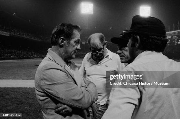 Bill Veeck, president of the Chicago White Sox, tries to reason with umpires and Sparky Anderson, Detroit Tiger manager, after a crowd rushed...