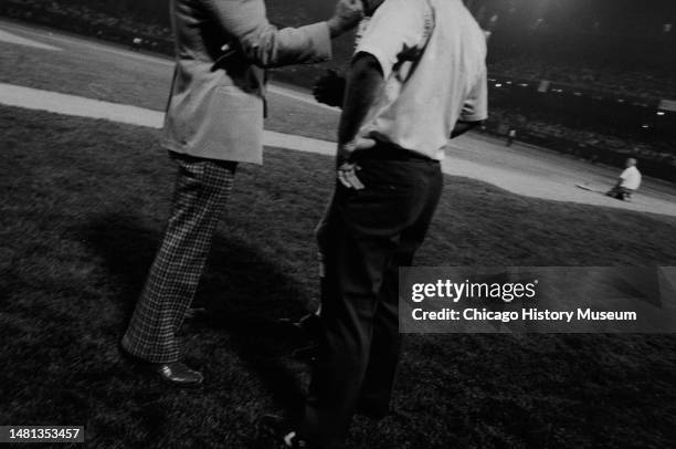 Bill Veeck, president of the Chicago White Sox, tries to reason with umpires and Sparky Anderson, Detroit Tiger manager, after a crowd rushed...