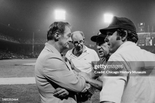 Bill Veeck, president of the Chicago White Sox, tries to reason with umpires and Sparky Anderson, Detroit Tiger manager, after a crowd rushed...