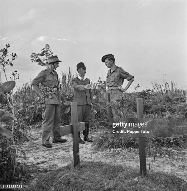 Koshiro Mikizawa, former commandant of Outram Road Prison, shows two Allied Intelligence Officers where prisoners were beheaded and buried during the...