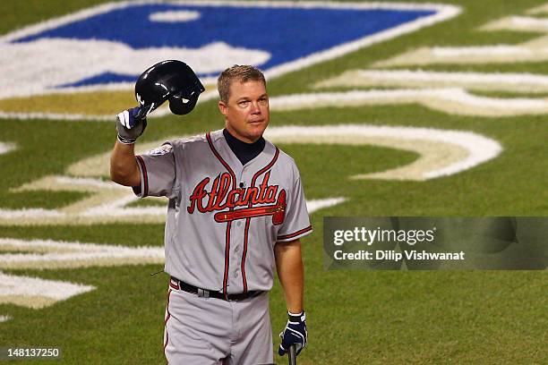 National League All-Star Chipper Jones of the Atlanta Braves takes off his helmet and waves to the crowd during his at bat in the sixth inning during...