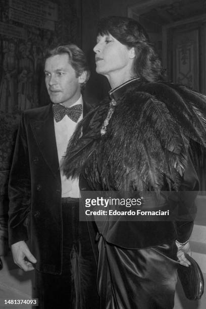 December 8 - The Italian actress and model Elsa Martinelli with the Austrian actor Helmut Berger at a party in Rome, December 8, 1979. .