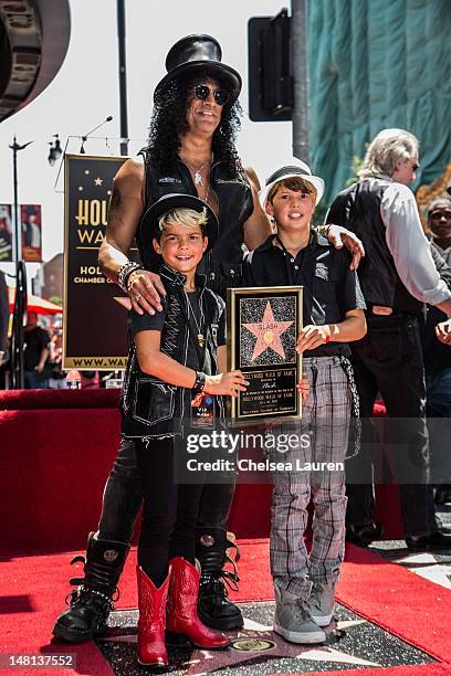 Guitarist Slash poses with his children Cash Hudson and London Hudson as he is honored with a star on the Hollywood Walk of Fame on July 10, 2012 in...