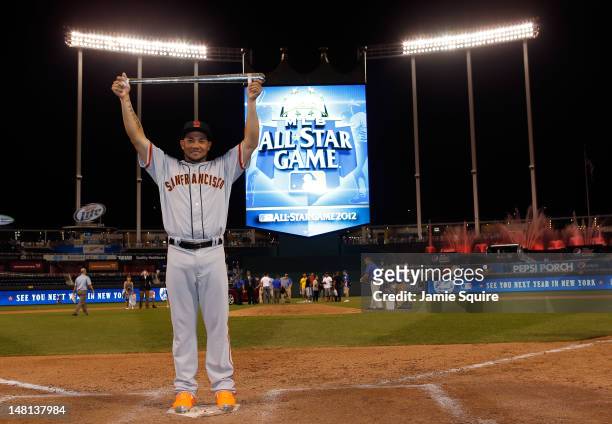 National League All-Star Melky Cabrera of the San Francisco Giants holds up the Ted Williams Most Valuable Player Award after the National League won...
