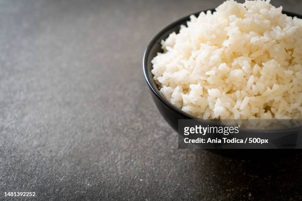 close-up of rice in bowl on table,romania - rice bowl stockfoto's en -beelden