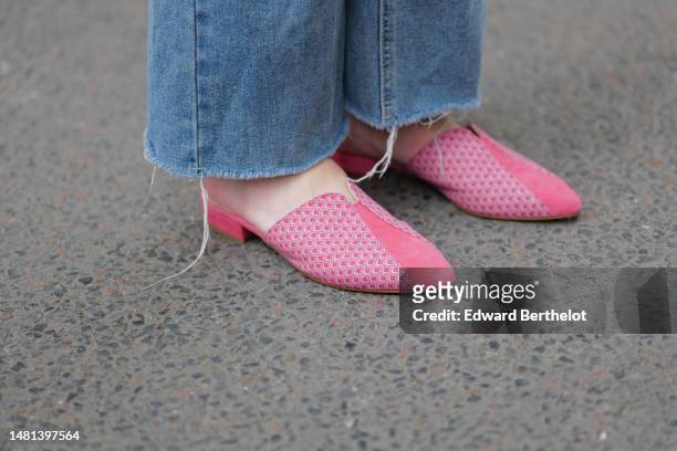 Alba Garavito Torre wears blue denim wide ripped legs pants, pink suede and leather print pattern flat mules from Mimush Madrid, during a street...