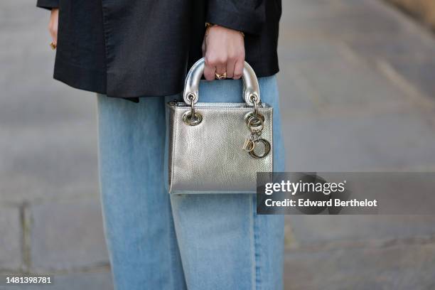 Alba Garavito Torre wears a dark gray oversized blazer jacket from Ksenia Karpenko, blue faded denim wide legs pants from Mother Denim, a silver...