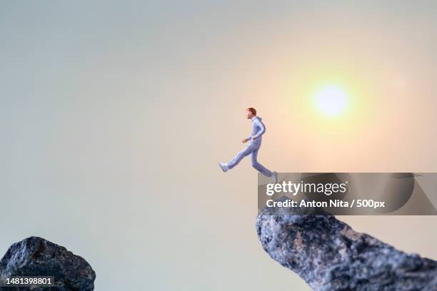 miniature people running on rock cliff with nature background,health and lifestyle concepts,romania - sunset cliffs stage stock pictures, royalty-free photos & images