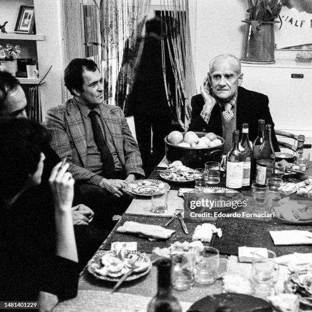 Alberto Moravia and Bernardo Bertolucci at dinner with friends, Rome, March 31, 1980.