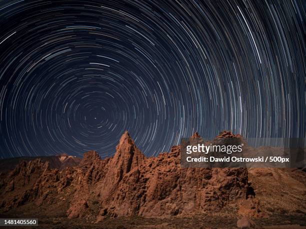 scenic view of star trails against sky at night,arafo,canary islands,spain - star trails stock pictures, royalty-free photos & images