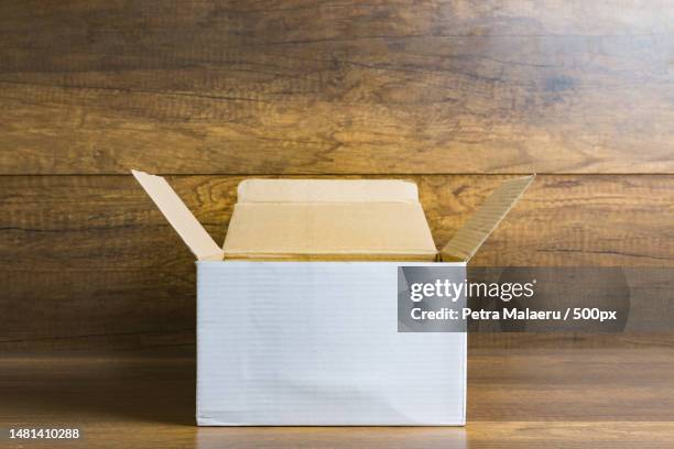close-up of cardboard box on table,romania - open romania imagens e fotografias de stock