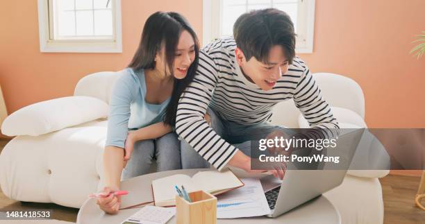 couple calculate finances at home - couple counting money stock pictures, royalty-free photos & images