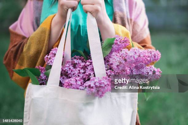 bouquet of pink purple lilac in female hands - may month stock pictures, royalty-free photos & images