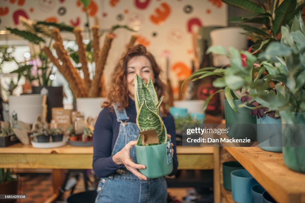 Female Business Owner Holding Plant