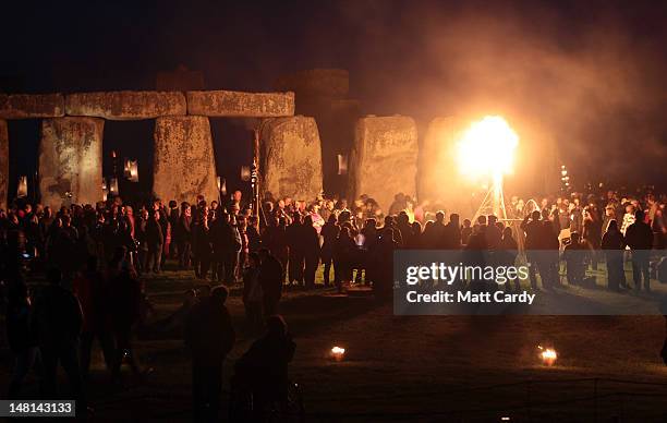 Fires light the ancient megalithic monument of Stonehenge during the Fire Garden as part of the Salisbury International Arts Festival on July 10,...
