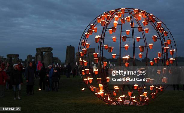 Fires light the ancient megalithic monument of Stonehenge during the Fire Garden as part of the Salisbury International Arts Festival on July 10,...