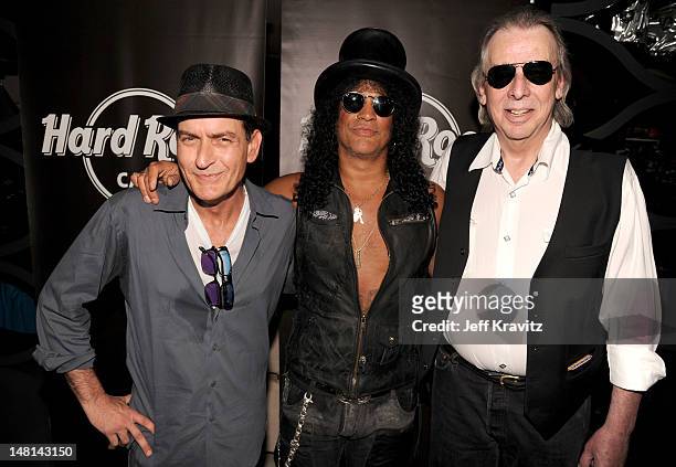 Charlie Sheen, Slash, and Jim Ladd pose after Slash's performance at the Hard Rock Cafe on July 10, 2012 in Hollywood, California.