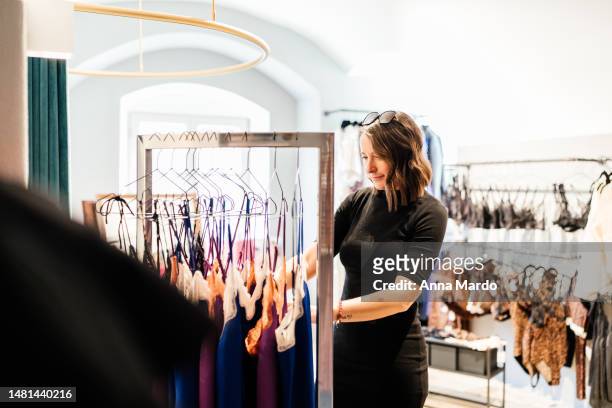 women looking at underwear in fashion shop. - body photos et images de collection