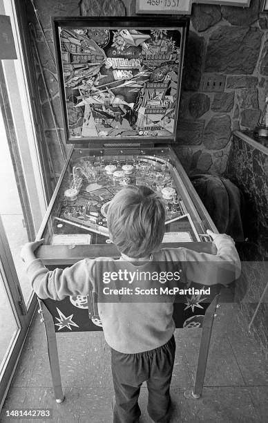 Rear view of a young boy as he plays pinball at Tony's Pizzeria on 63rd Drive , in Queens' Rego Park neighborhood, New York, New York, January 11,...