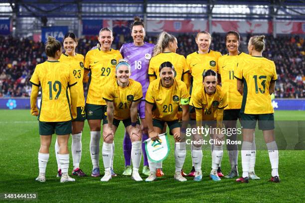 Players of Australia pose for a team photograph, as Katrina Gorry, Charlotte Grant and Tameka Yallop show nameless shirts in support of the...