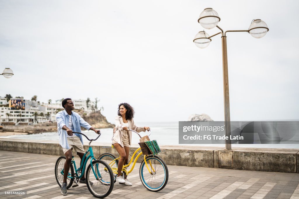 Young couple during a bike ride on the coastline