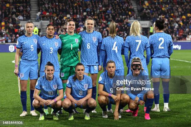 Players of England pose for a team photograph, as Kiera Walsh, Chloe Kelly and Lucy Bronze show nameless shirts in support of the Alzheimer's...