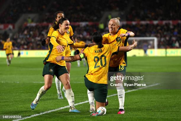 Sam Kerr of Australia celebrates after scoring the team's first goal with teammates during the Women's International Friendly match between England...