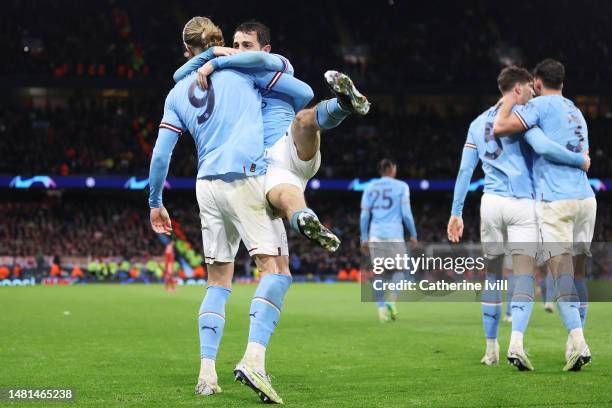 Erling Haaland of Manchester City celebrates with teammate Bernardo Silva after scoring the team's third goal during the UEFA Champions League...