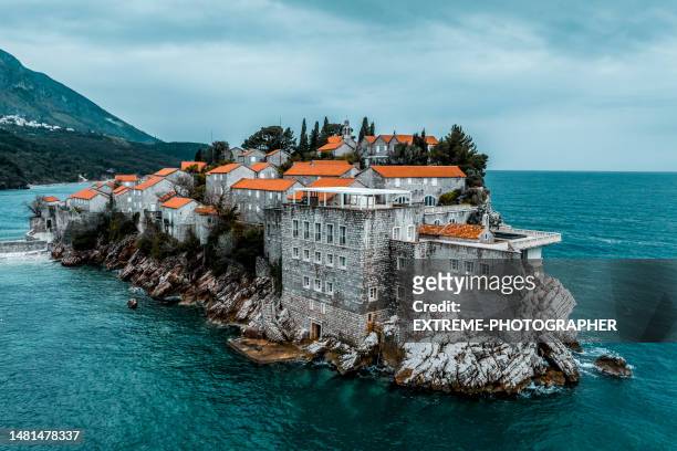 sveti stefan seen from above in the emerald waters of the adriatic sea - sveti stefan stock pictures, royalty-free photos & images