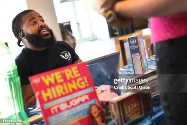 Damien Lee of It'sSugar, a candy store chain, interviews a job applicant during a job fair at Navy Pier on April 11, 2023 in Chicago, Illinois. The...