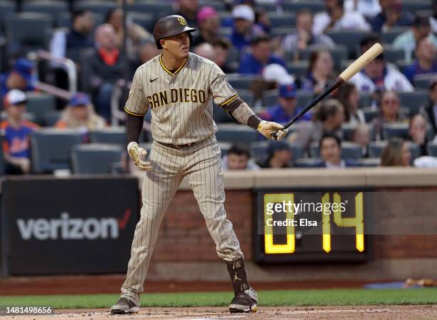 Manny Machado of the San Diego Padres takes his turn at bat in the first inning against the New York Mets as the pitch clock winds down behind at...