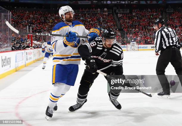 Alex Tuch of the Buffalo Sabres gets the stick up on Kevin Bahl of the New Jersey Devils during the first period at the Prudential Center on April...