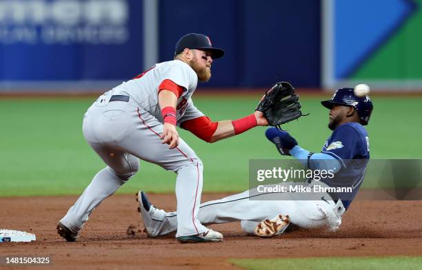 Christian Arroyo of the Boston Red Sox tags out Vidal Brujan of the Tampa Bay Rays trying to steal in the first inning during a game at Tropicana...