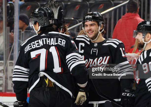 Nico Hischier celebrates a second period goal by Jonas Siegenthaler of the New Jersey Devils against the Buffalo Sabres at the Prudential Center on...