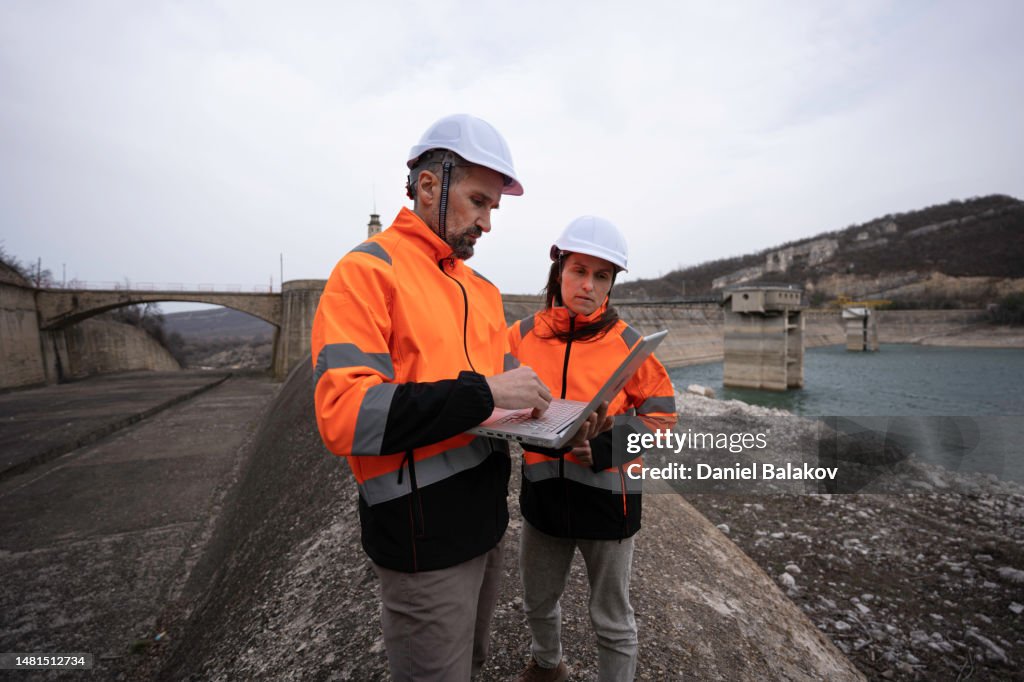 Engineers working in hydroelectric power station.