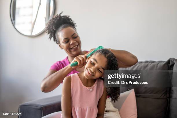 mother combing daughter's hair - woman combing her hair stock pictures, royalty-free photos & images