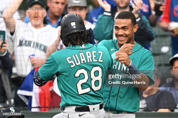 Julio Rodriguez and Eugenio Suarez of the Seattle Mariners celebrate after the two run home run in the first inning against the Chicago Cubs at...