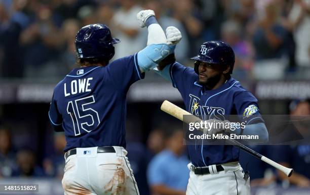 Josh Lowe of the Tampa Bay Rays is congratulated after hitting a home run in the seventh inning during a game against the Boston Red Sox at Tropicana...