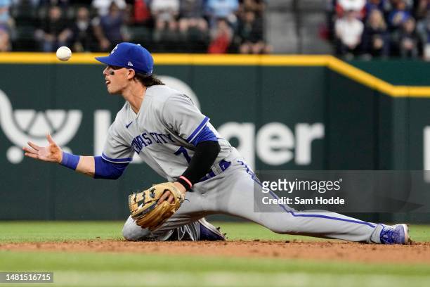 Bobby Witt Jr. #7 of the Kansas City Royals watches a ground ball bounce past him during the third inning against the Texas Rangers at Globe Life...