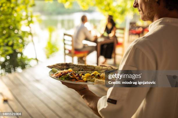 waiter carrying seafood - empregado de mesa imagens e fotografias de stock