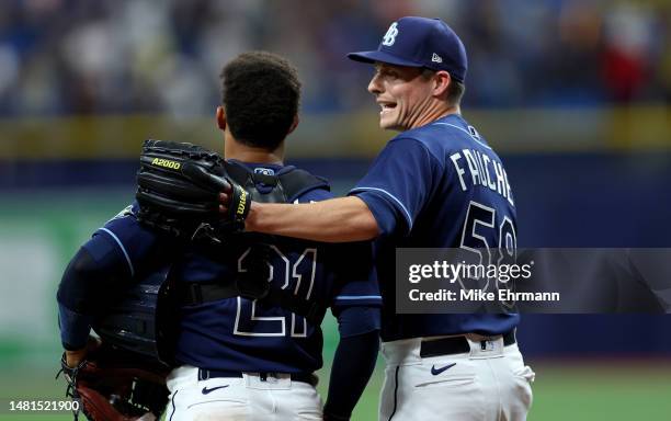 Calvin Faucher and Francisco Mejia of the Tampa Bay Rays celebrate winning a game against the Boston Red Sox at Tropicana Field on April 11, 2023 in...