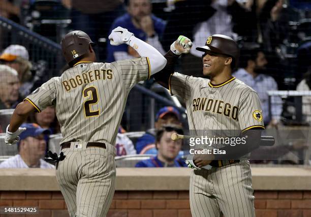 Xander Bogaerts of the San Diego Padres is congratulated by teammate Juan Soto after Bogaerts hit a two run home run in the ninth inning against the...